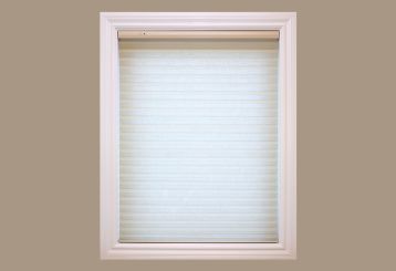 Radiance Cordless Driftwood Roman Shade installed on a window, highlighting the natural texture and modern elegance.