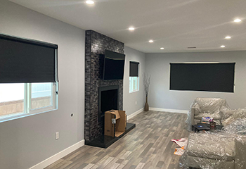 Modern living room with fireplace and blackout roller shades