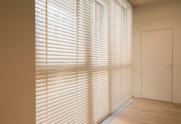 Faux wood blinds installed on a bedroom window