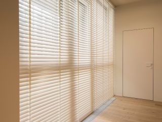 Faux wood blinds installed on a bedroom window